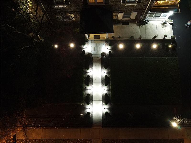 Landscape lighting illuminating hardscape and planting in Overbrook Farms on the Main Line of Pennsylvania.