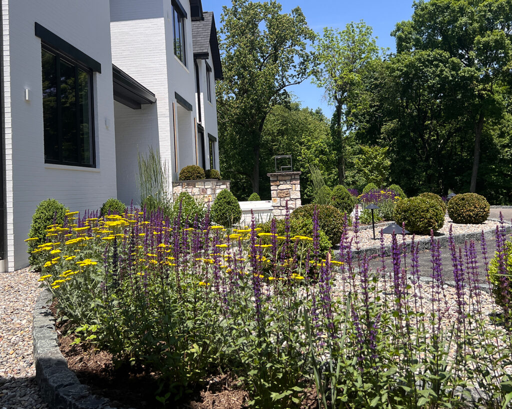 Close-up view of colorful perennial plantings at the front of a modern farmhouse property in Christiana, Pennsylvania