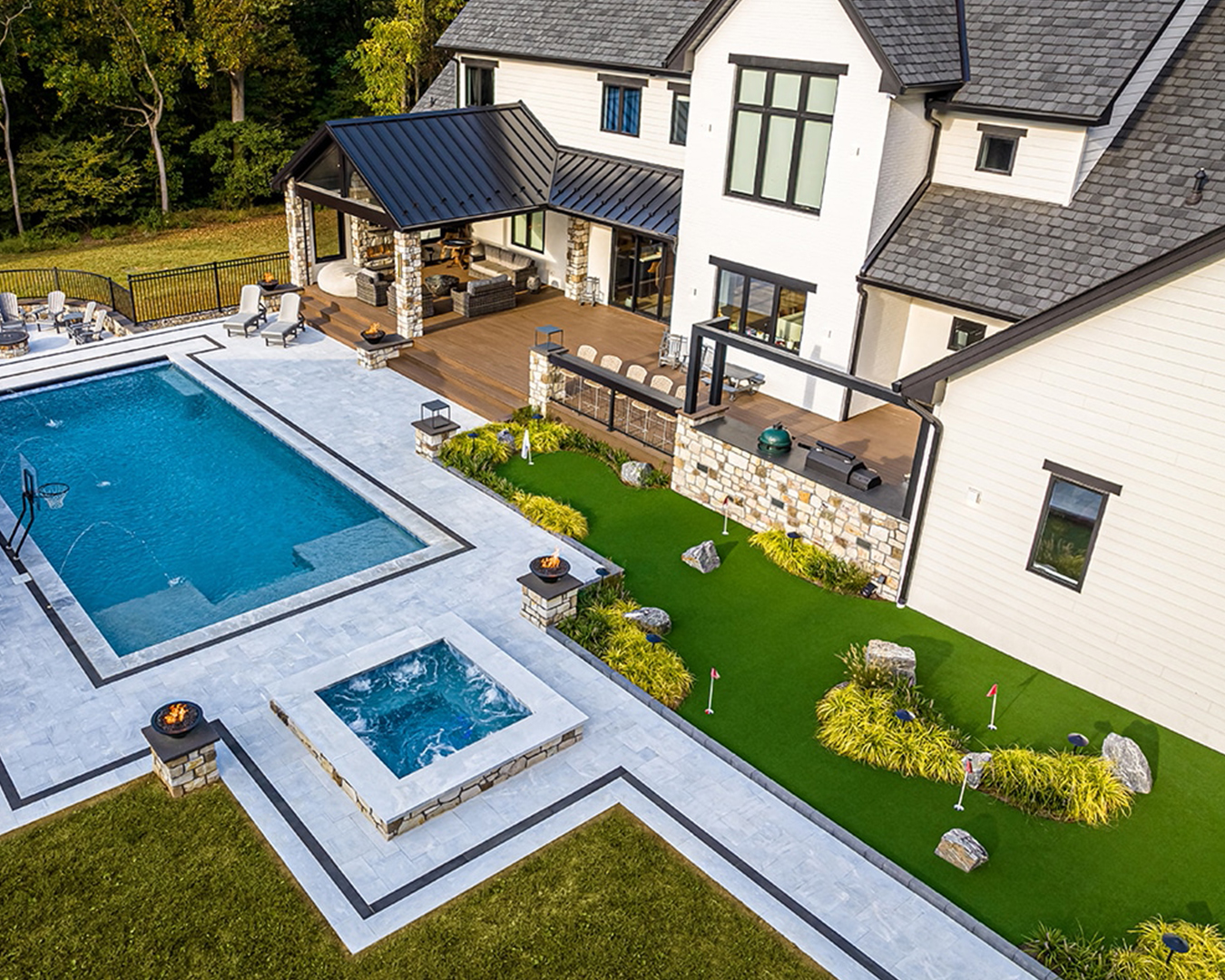 Overhead view of putting green, pool, and surrounding perennial plantings at a modern farmhouse property in Christiana, Pennsylvania